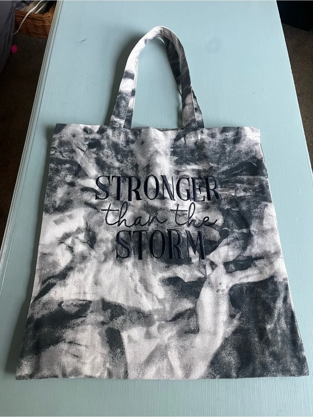 Medium tote bag black and white tie die “Strong than the Storm” on the bag